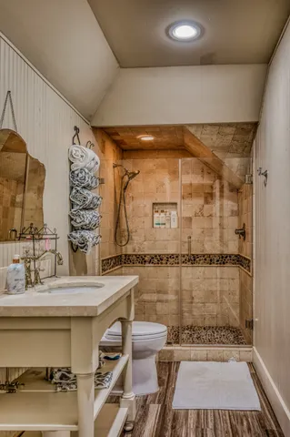 a bathroom with a sink toilet and shower