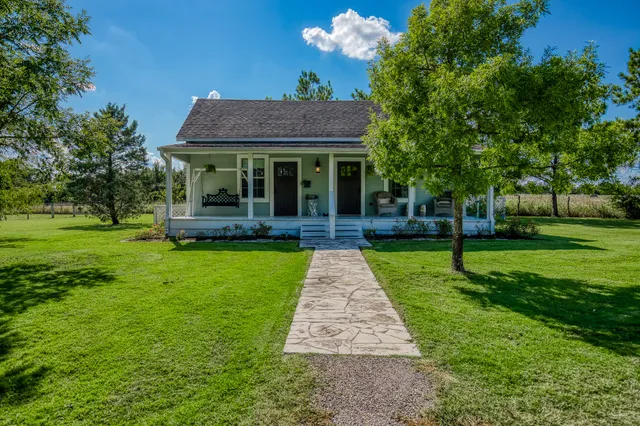 a front view of a house with garden