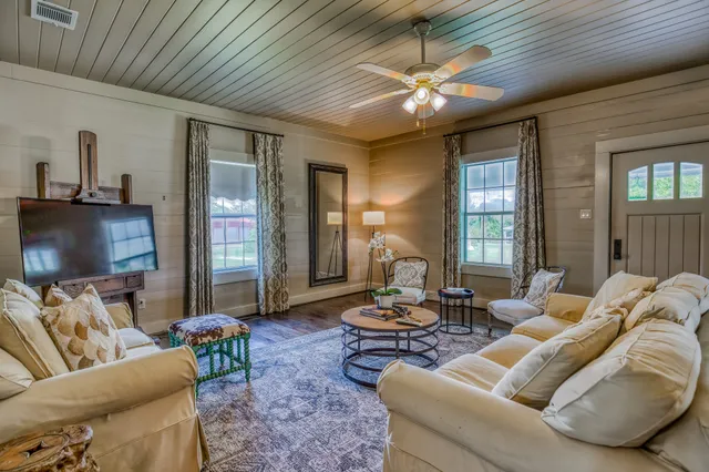 a living room with furniture and a chandelier