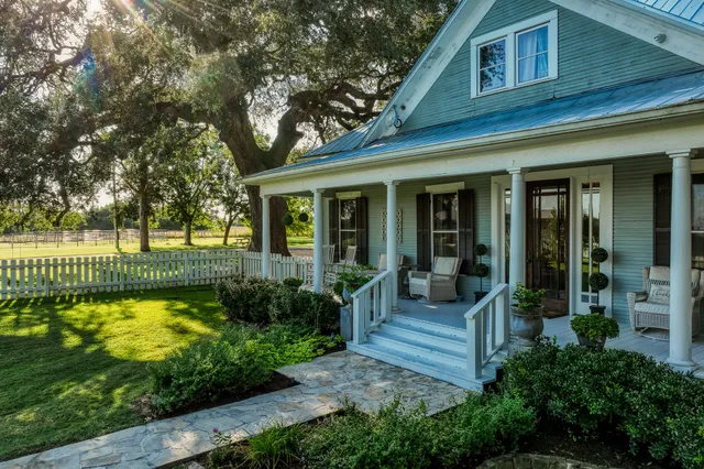 a view of a house with a swimming pool and porch with furniture