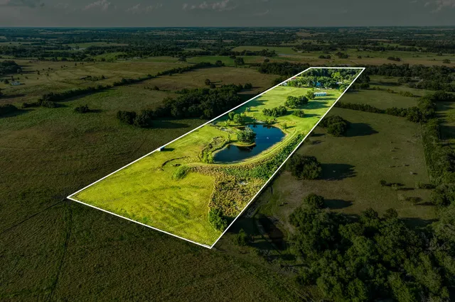 a view of a backyard with lawn chairs