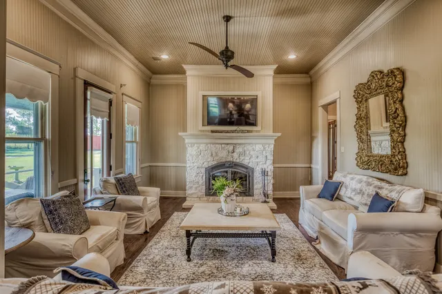 a living room with furniture fireplace and window