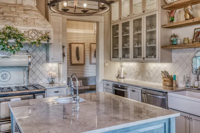 a kitchen with stainless steel appliances granite countertop a stove and a sink