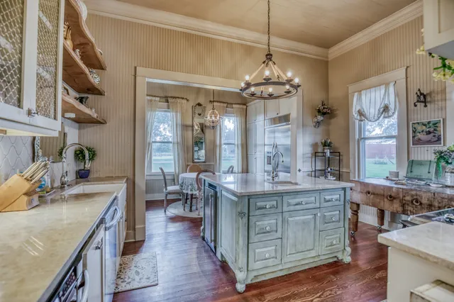 a view of a kitchen counter space dining table and wooden floor