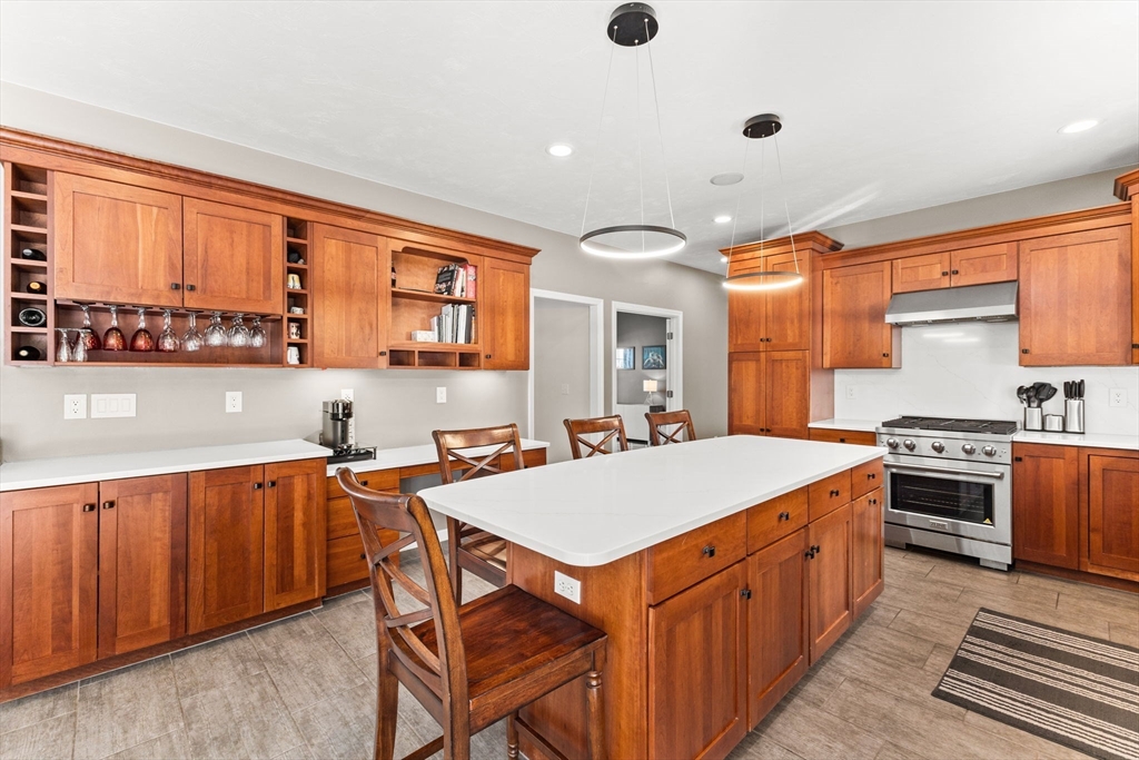 20 Mohawk Road Raynham, MA 02767 - Photo 11 of 42 a kitchen with stainless steel appliances granite countertop a stove a sink dishwasher and a refrigerator with wooden cabinets