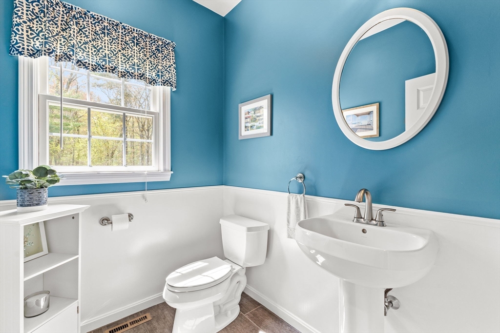 20 Mohawk Road Raynham, MA 02767 - Photo 27 of 42 a bathroom with a sink and mirror with toilet