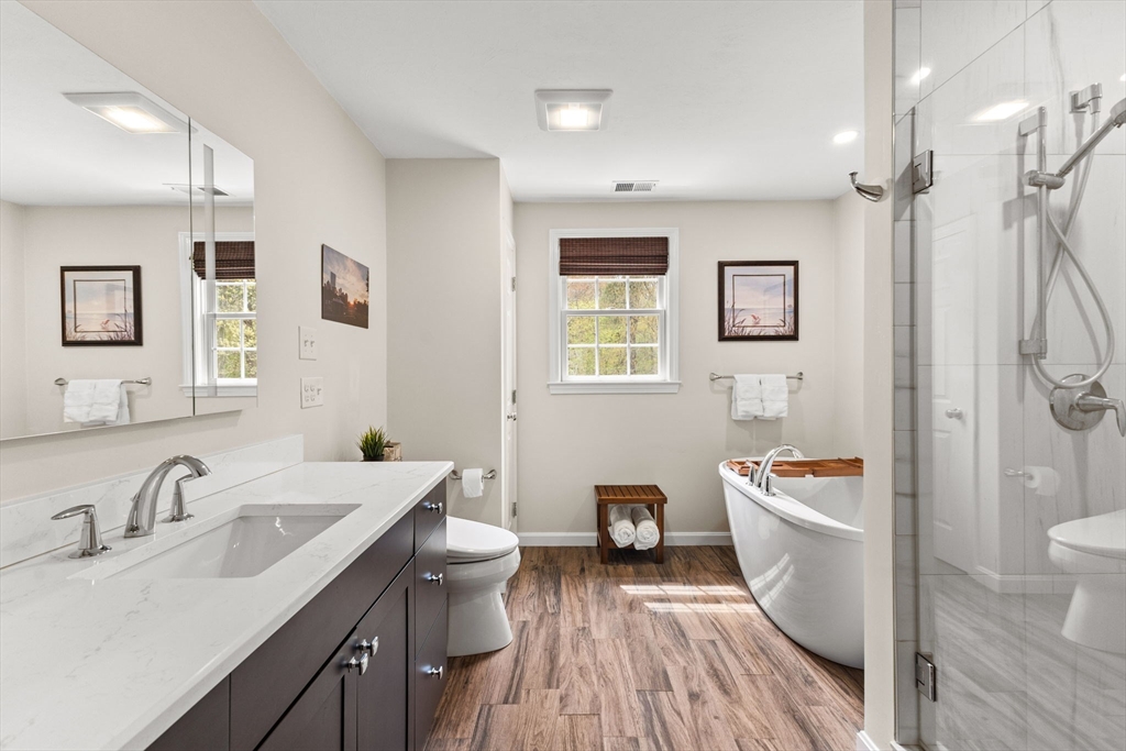 20 Mohawk Road Raynham, MA 02767 - Photo 31 of 42 a bathroom with a sink toilet a mirror and shower