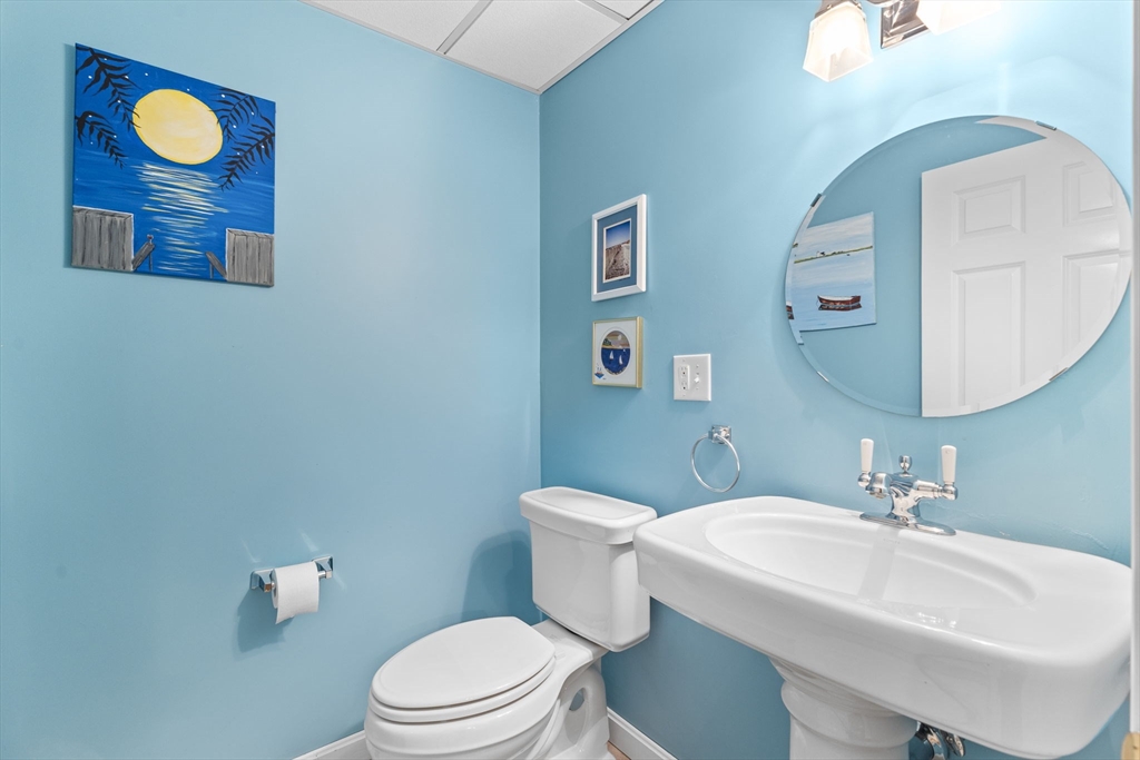 20 Mohawk Road Raynham, MA 02767 - Photo 40 of 42 a bathroom with a toilet a sink and mirror