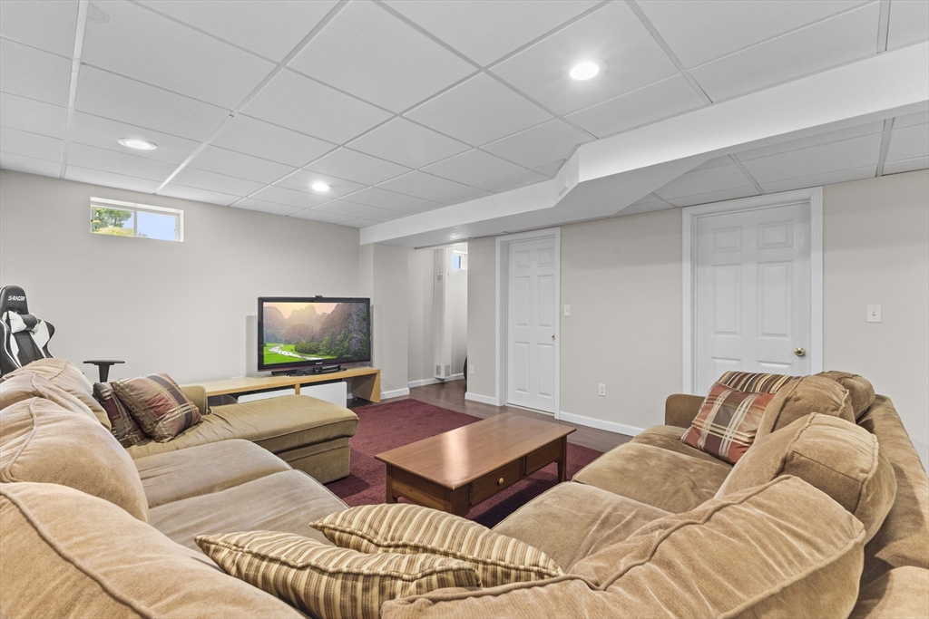 20 Mohawk Road Raynham, MA 02767 - Photo 42 of 42 a living room with furniture and a flat screen tv