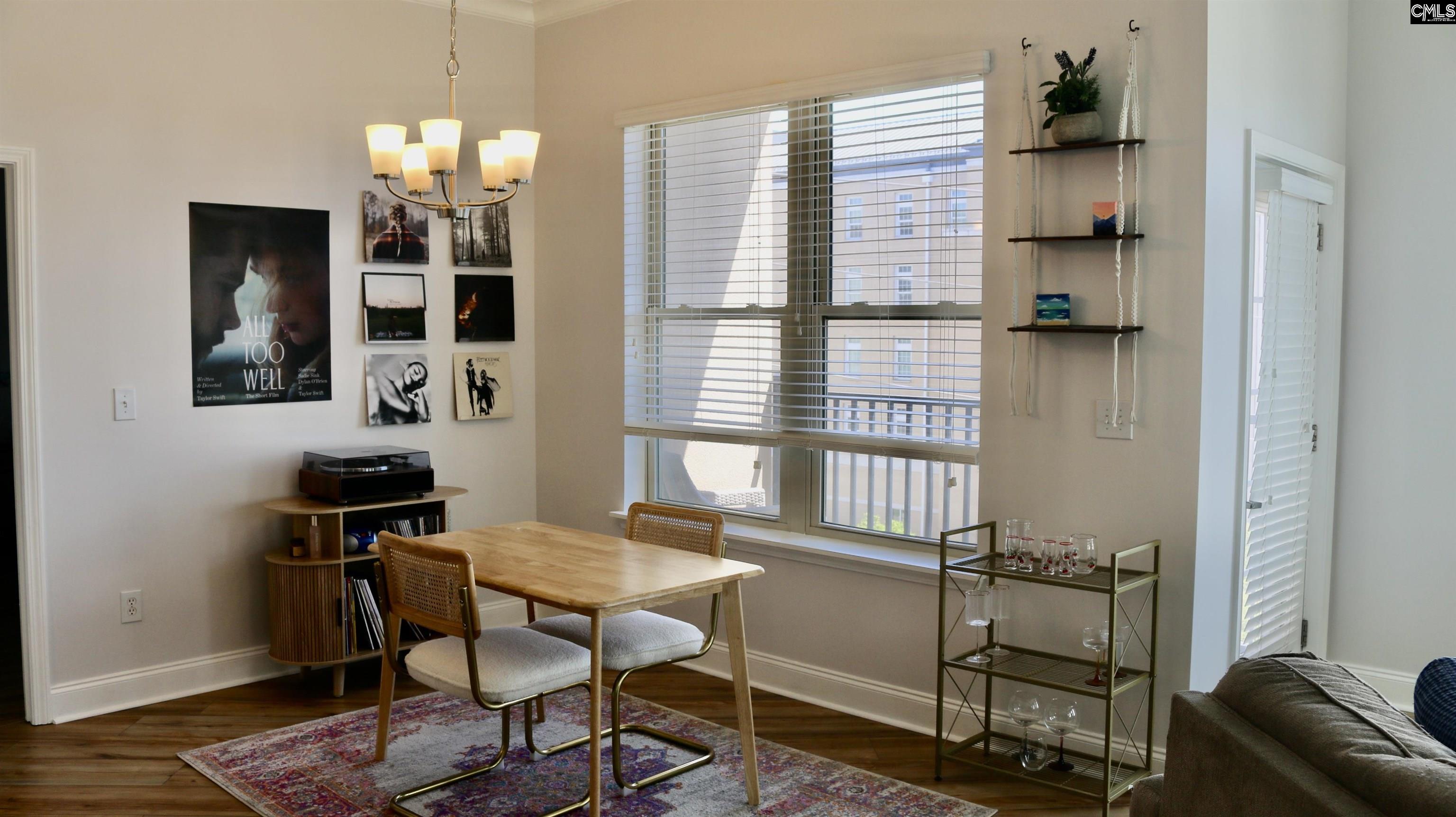 601 Main Street, Unit 323 Columbia, SC 29201 - Photo 20 of 68 a view of a dining room with furniture and wooden floor