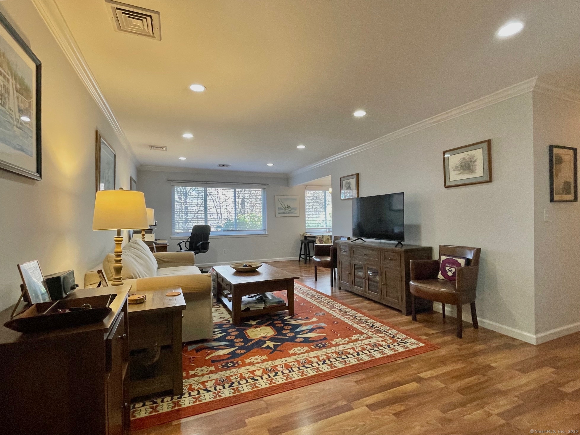 214 Southport Woods Drive, Unit 214 Fairfield, CT 06890 - Photo 1 of 1 a living room with furniture a flat screen tv and a dining table