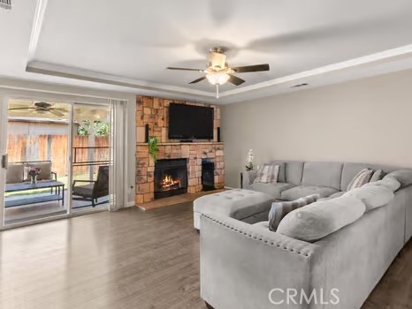 11191 Baker Lane Riverside, CA 92505 - Photo 11 of 49 a living room with furniture a fireplace and a flat screen tv