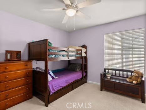 11191 Baker Lane Riverside, CA 92505 - Photo 15 of 49 a bedroom with a bed and a chandelier