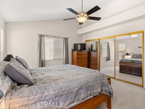 11191 Baker Lane Riverside, CA 92505 - Photo 24 of 49 a bedroom with a large bed and a chandelier