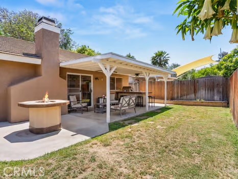 11191 Baker Lane Riverside, CA 92505 - Photo 37 of 49 a view of a patio with table and chairs and potted plants with wooden fence