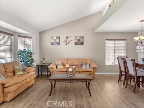 11191 Baker Lane Riverside, CA 92505 - Photo 7 of 49 a living room with furniture a wooden floor and a potted plant