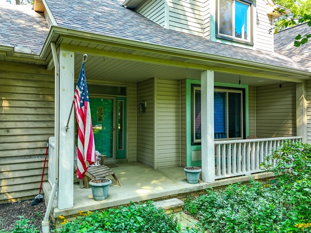 View of exterior entry with covered porch