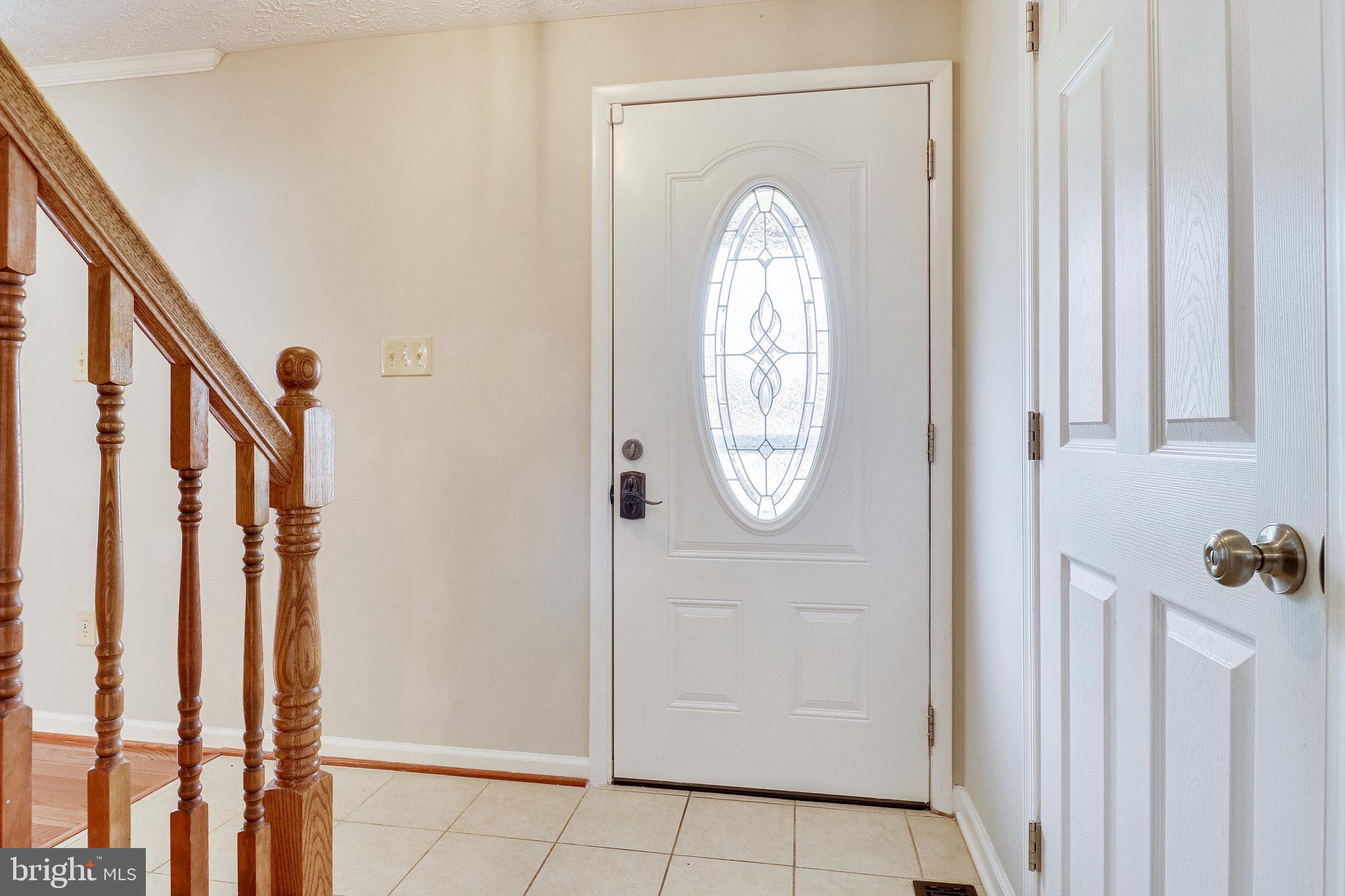 8492 Magic Tree Court Springfield, VA 22153 - Photo 17 of 65 Tile foyer opens to LR, coat closet & upstairs