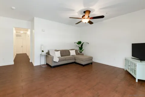 an empty room with a ceiling fan and bathroom