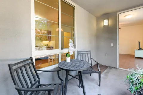 a view of a room with furniture and wooden floor