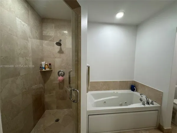 a bathroom with a tub and a shower