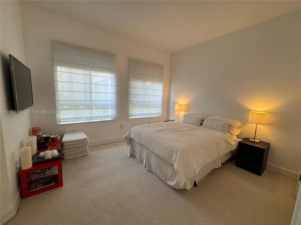 a spacious bedroom with a bed and a couch