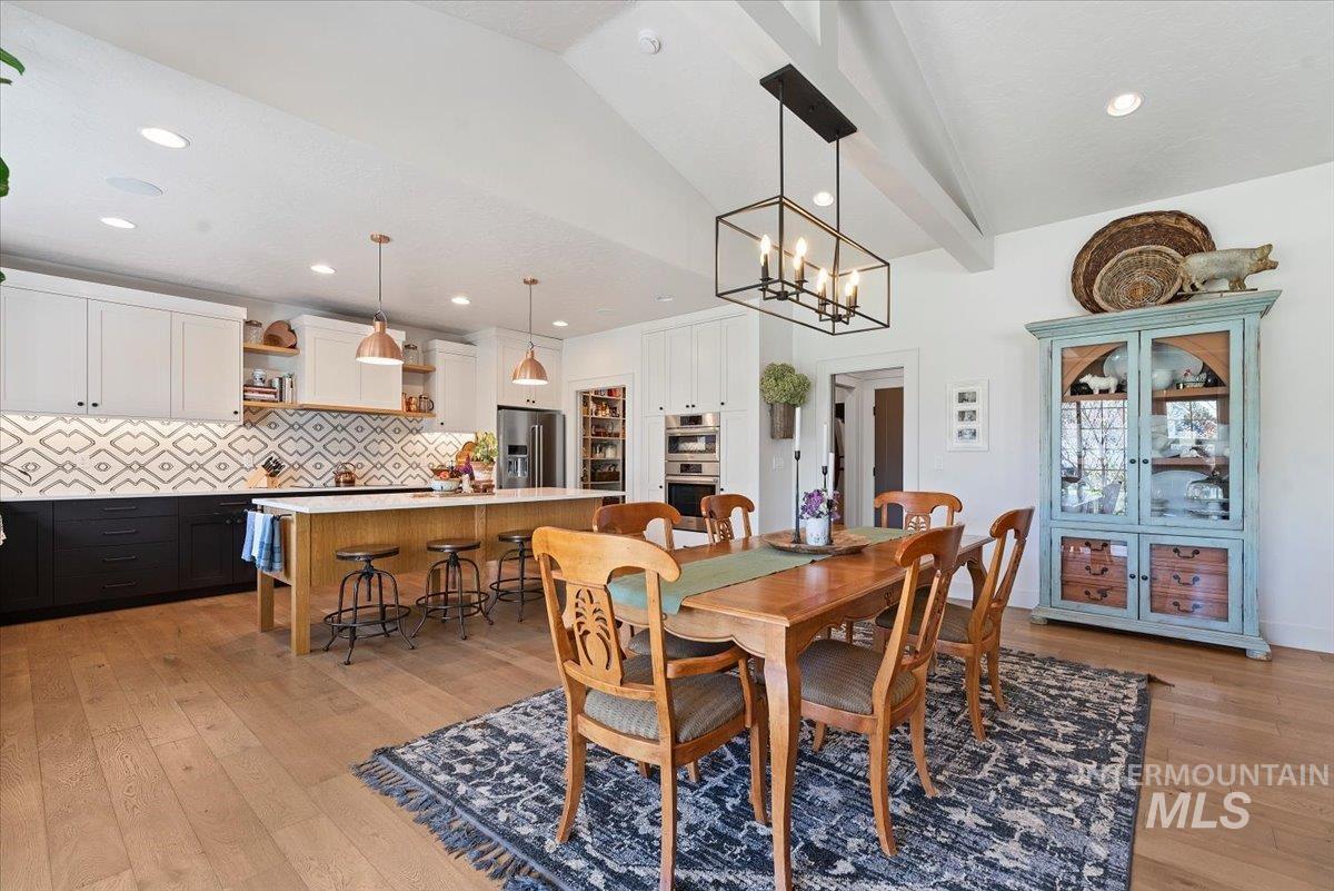 15164 Pinehurst Way Caldwell, ID 83607 - Photo 13 of 50 Open-concept kitchen and dining area with vaulted ceiling and exposed beams
