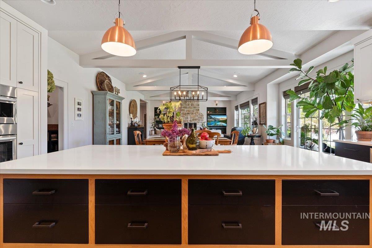 15164 Pinehurst Way Caldwell, ID 83607 - Photo 17 of 50 Spacious kitchen island with a white countertop and wood-finish base, featuring four black cabinet drawers