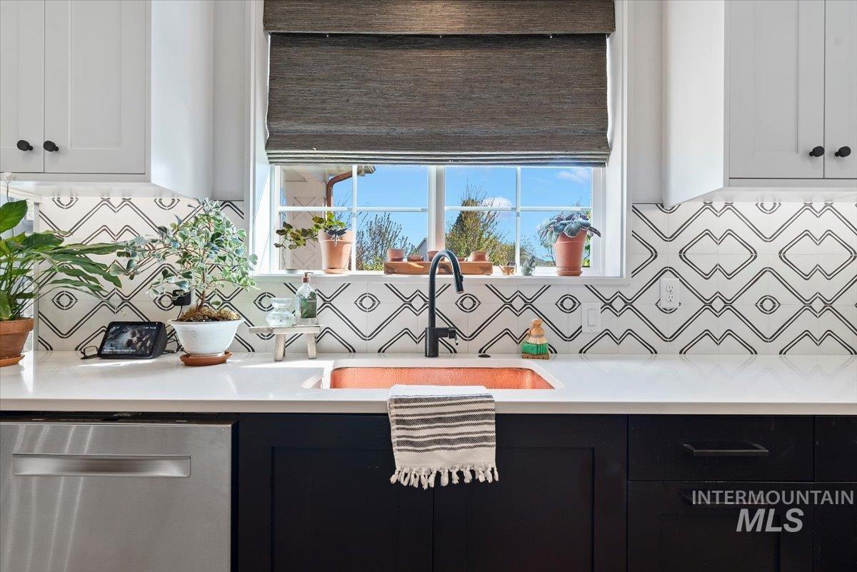 15164 Pinehurst Way Caldwell, ID 83607 - Photo 19 of 50 Kitchen featuring a copper sink, white countertops, and a distinct geometric-patterned tile backsplash