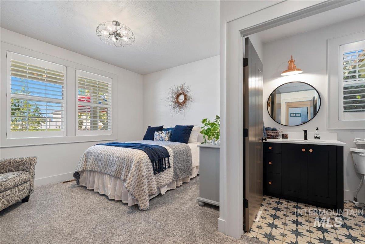 15164 Pinehurst Way Caldwell, ID 83607 - Photo 29 of 50 Bedroom featuring two windows with white plantation shutters and a ceiling-mounted light fixture & full bath