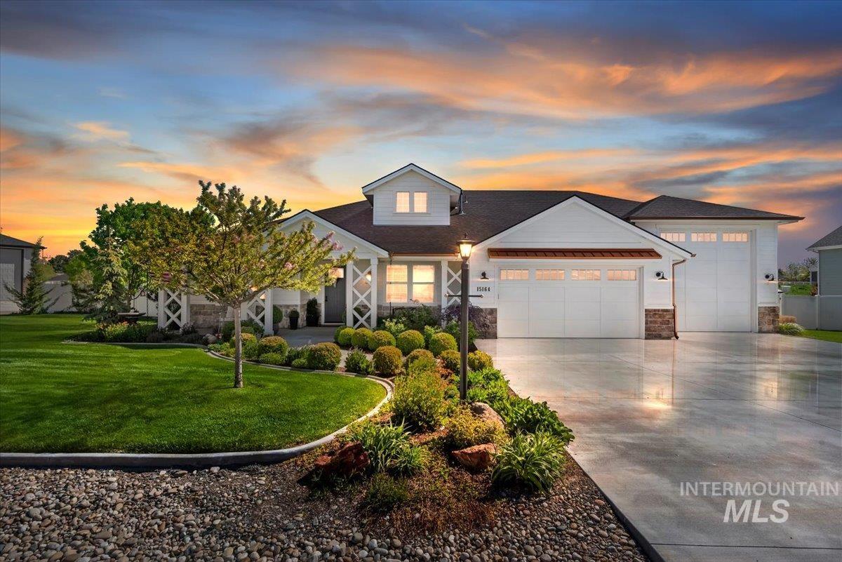 15164 Pinehurst Way Caldwell, ID 83607 - Photo 3 of 50 Contemporary residence featuring white siding, a dark roof, and stone accents