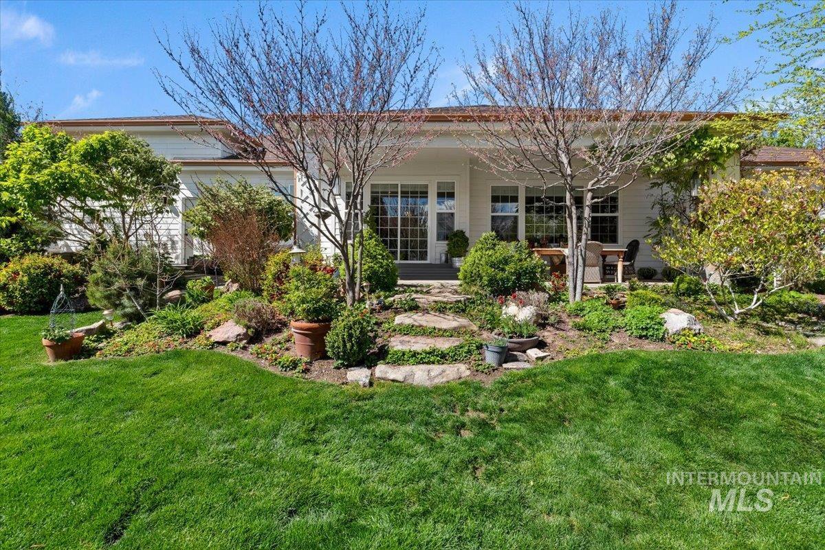 15164 Pinehurst Way Caldwell, ID 83607 - Photo 40 of 50 Expansive green lawn bordering a terraced garden with stone steps and mature plantings