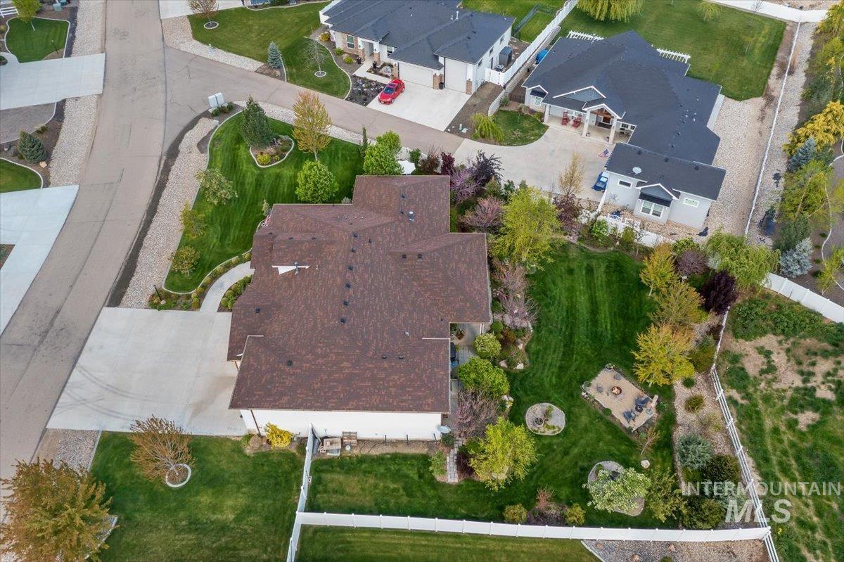 15164 Pinehurst Way Caldwell, ID 83607 - Photo 47 of 50 Expansive property with a large, landscaped backyard featuring mature trees, a manicured lawn, and a designated fire pit area