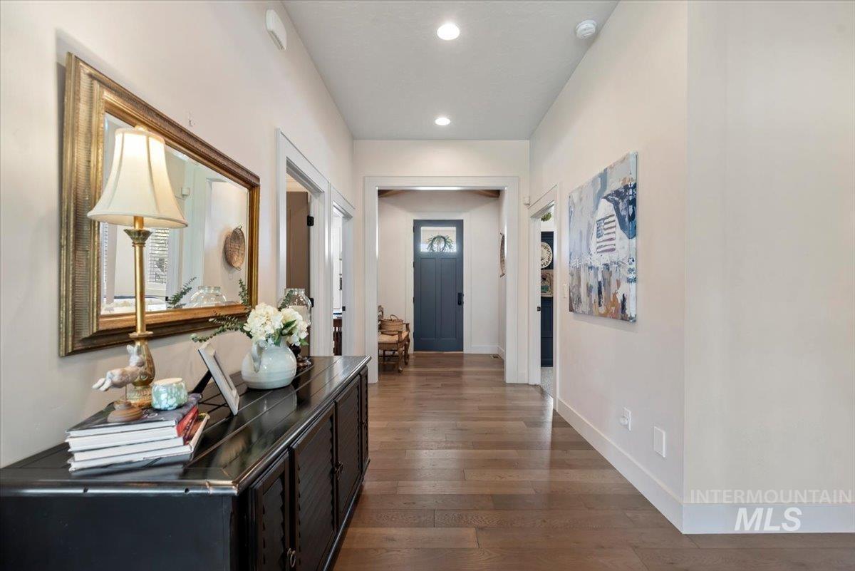 15164 Pinehurst Way Caldwell, ID 83607 - Photo 6 of 50 Long hallway featuring wood-finish flooring, recessed ceiling lighting, and white baseboards