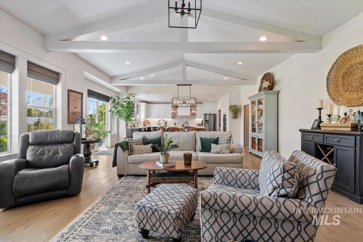 15164 Pinehurst Way Caldwell, ID 83607 - Photo 10 of 50 Spacious living area featuring vaulted ceilings with exposed beams, recessed lighting, wood-finish flooring, and multiple large windows