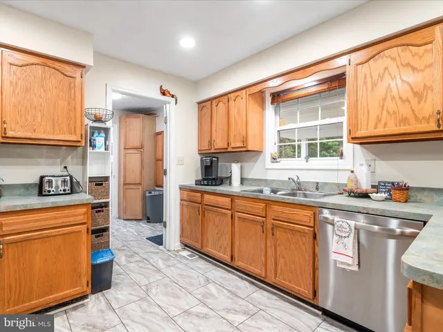 a kitchen with stainless steel appliances granite countertop a stove a sink dishwasher and a refrigerator