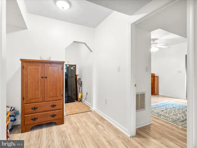 a view of a bedroom with furniture and wooden floor