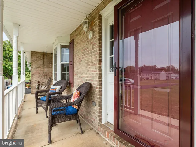 a balcony with furniture and a potted plant
