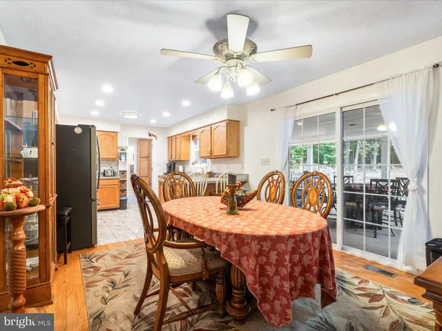 a dining room with furniture a chandelier and wooden floor