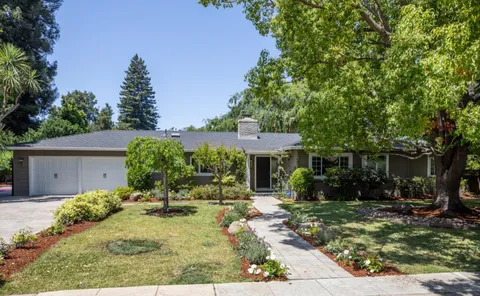 a backyard of a house with yard and outdoor seating