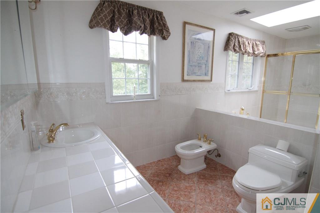 15 Gramercy Road Monmouth Junction, NJ 08852 - Photo 12 of 17 a bathroom with a toilet sink and mirror