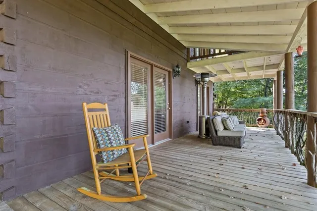 a roof deck with couches and wooden floor