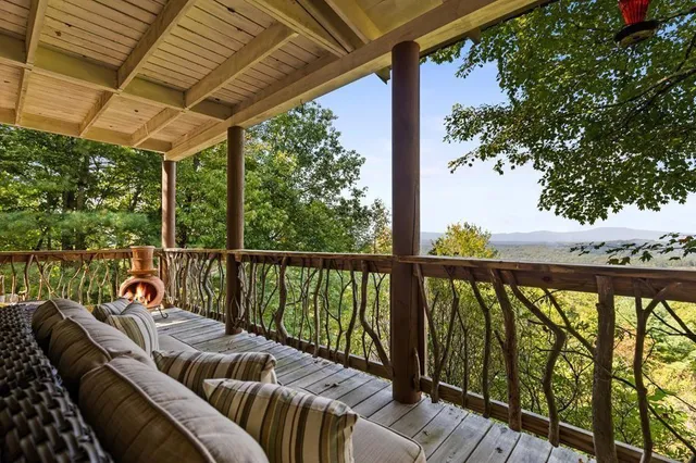 a view of a balcony with chair and wooden floor