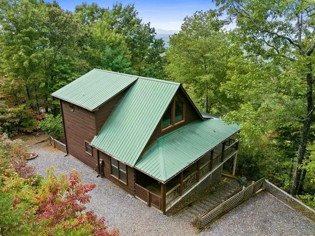 a view of a backyard with a small deck and a garden