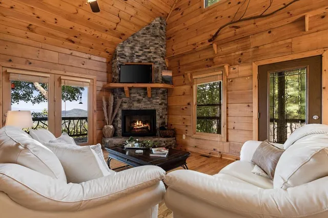 a living room with furniture and a fireplace