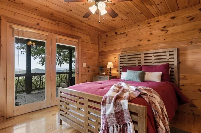 a bed sitting in a bedroom next to a window