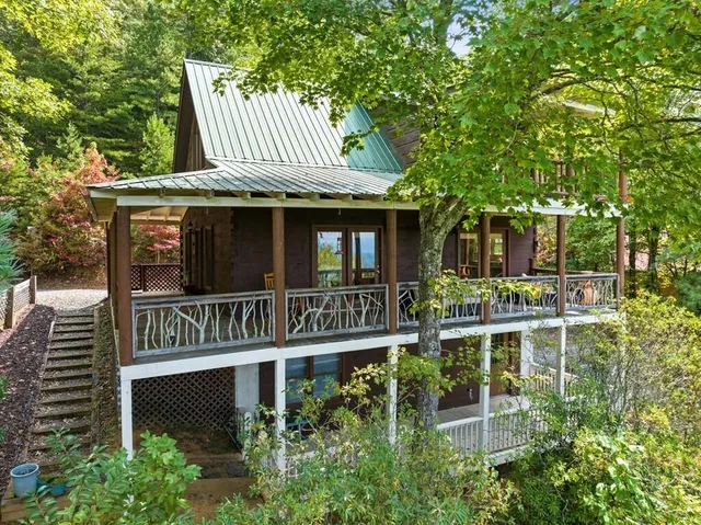 a view of a house with a small yard and wooden fence