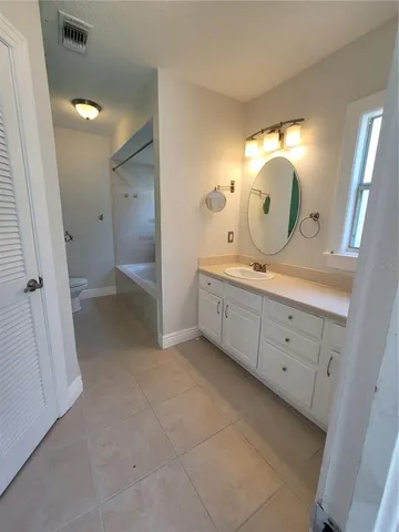 a spacious bathroom with a double vanity sink and a mirror