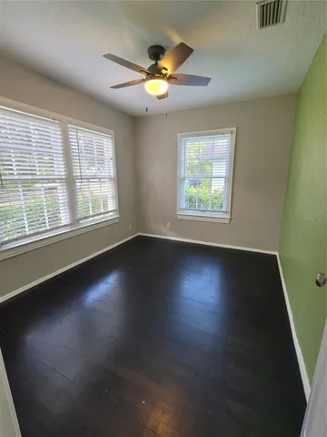 a view of room with window and wooden floor