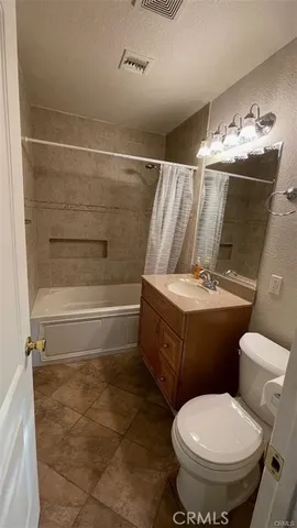 a bathroom with a toilet sink and shower